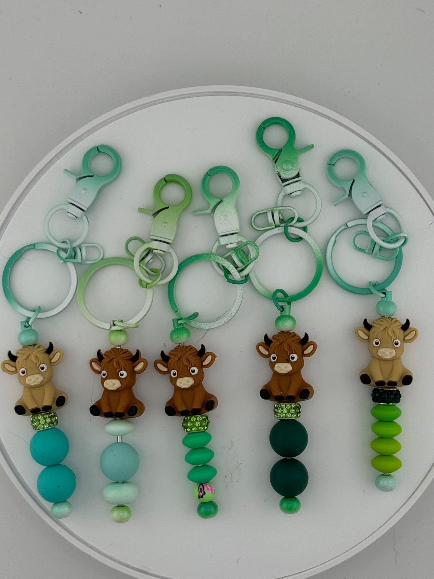 Playful 3D Cows on Green keychains